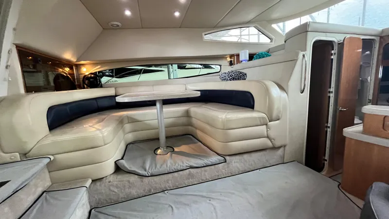 Slide: The Image of Interior of 2002 Regal Commodore 3880 yacht with beige leather seating and dining table. - 17