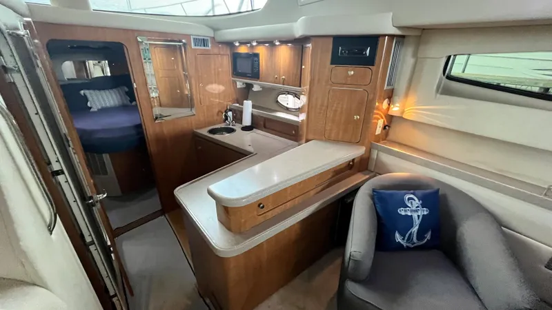Slide: The Image of 2002 Regal Commodore 3880 yacht interior with kitchenette and seating area. - 19