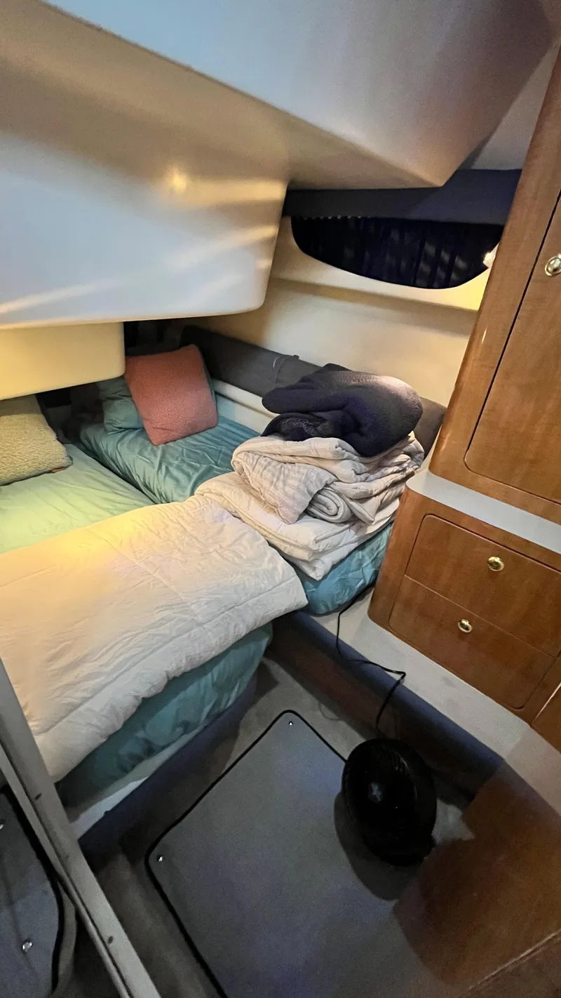 Slide: The Image of Cozy cabin interior of a 2002 Regal Commodore 3880 yacht with bedding and storage. - 20