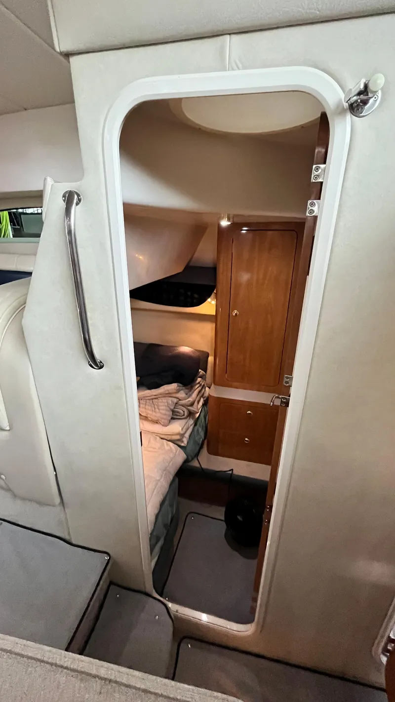 Slide: The Image of Interior cabin of 2002 Regal Commodore 3880 yacht with cozy bed and wooden cabinets. - 21
