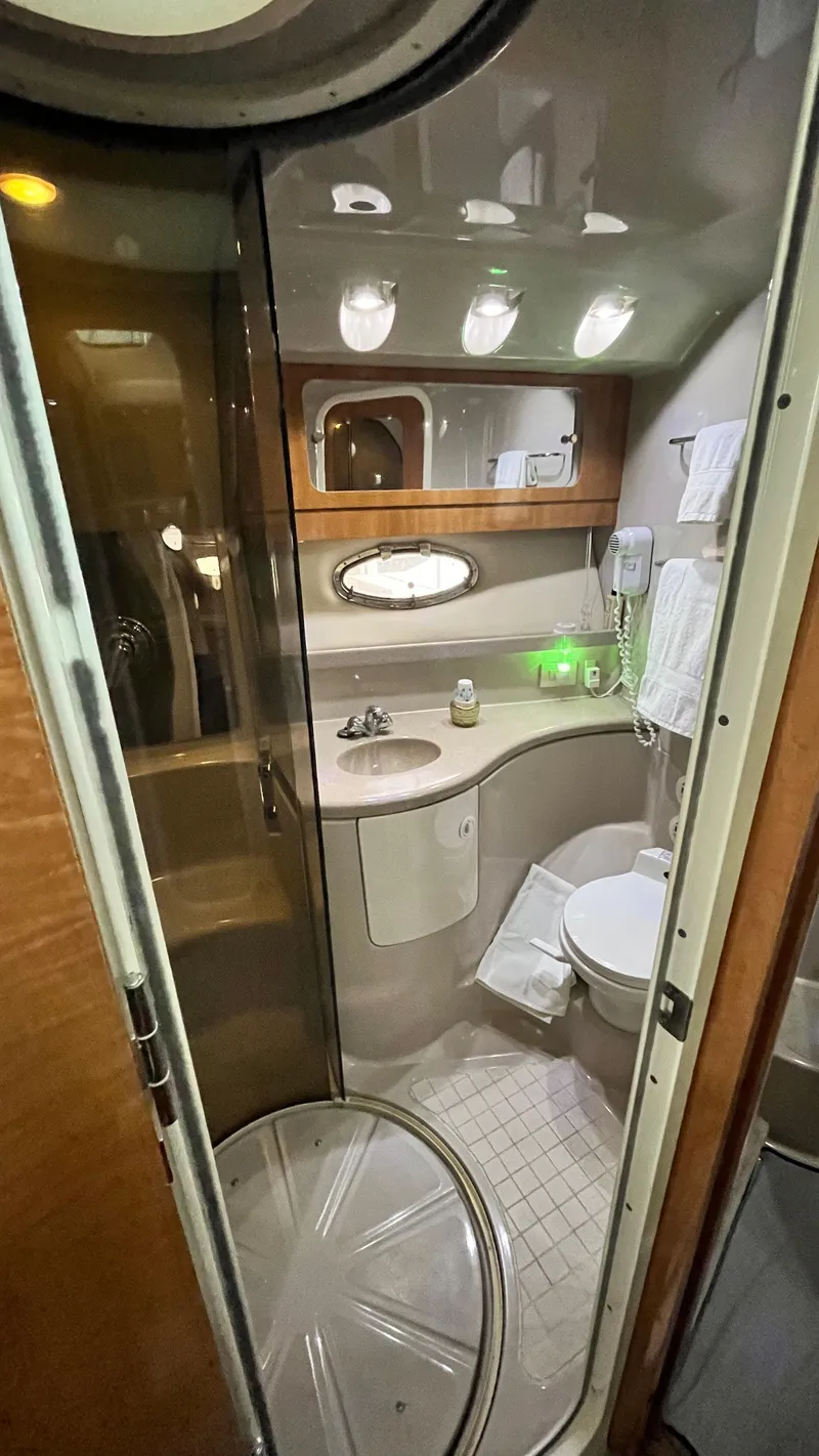 Slide: The Image of Compact bathroom in 2002 Regal Commodore 3880 yacht with modern fixtures and ample storage. - 24