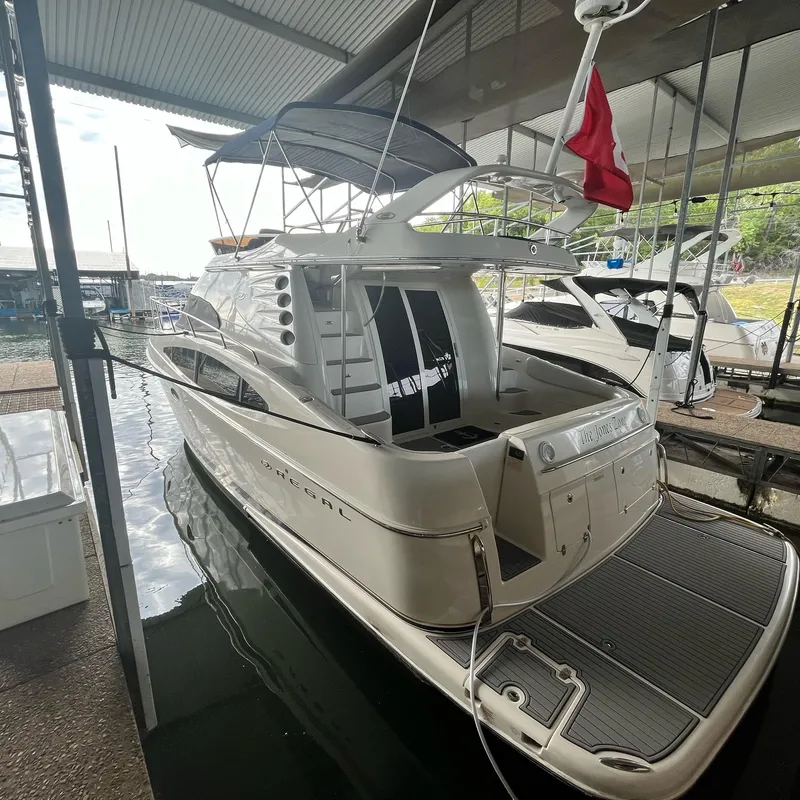 Slide: The Image of 2002 Regal Commodore 3880 yacht docked in a covered marina. - 3