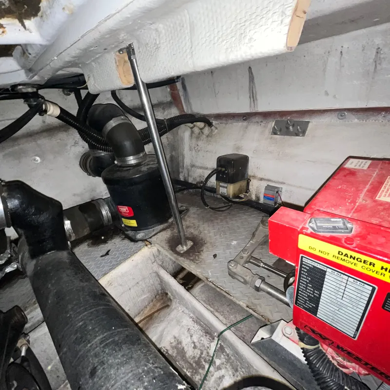 Slide: The Image of Engine compartment of a 2002 Regal Commodore 3880 boat with various mechanical components. - 32