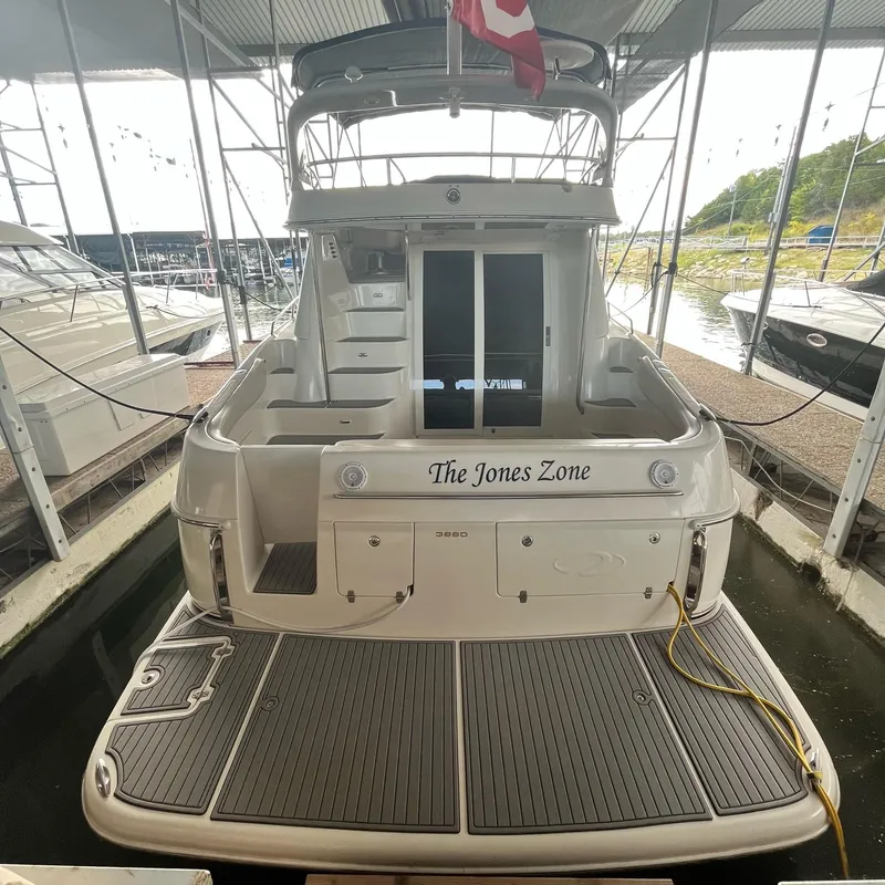 Slide: The Image of 2002 Regal Commodore 3880 yacht docked, rear view with The Jones Zone name. - 4