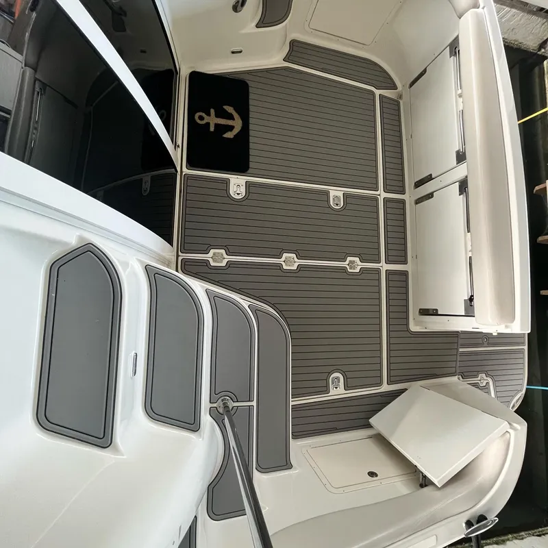 Slide: The Image of 2002 Regal Commodore 3880 boat interior with gray flooring and storage compartments. - 7