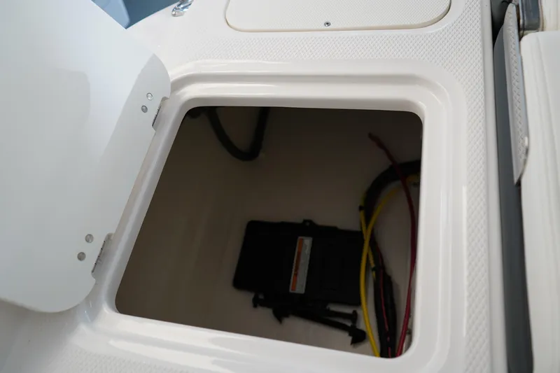 Slide: The Image of 2024 Chaparral 23 SSi OB storage compartment with wiring visible. - 10