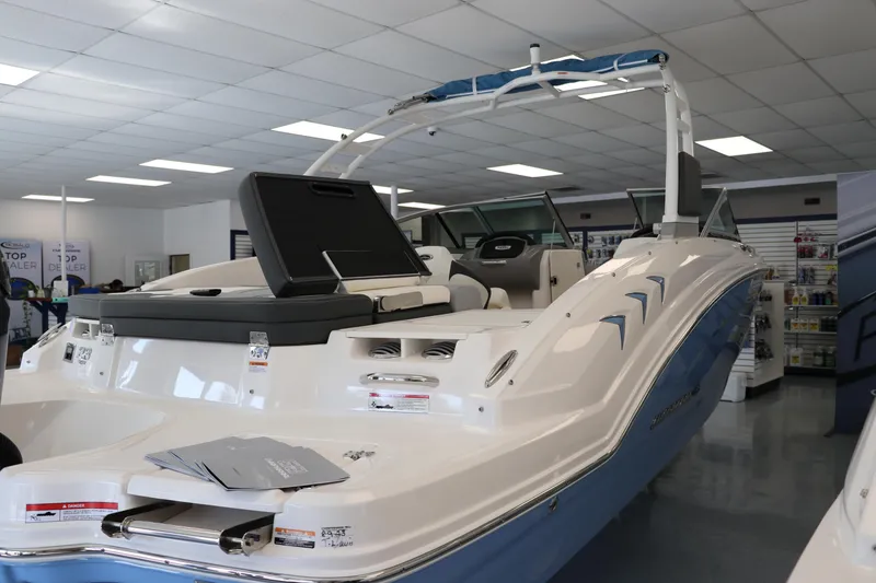 Slide: The Image of 2024 Chaparral 23 SSi OB boat displayed in a showroom, featuring sleek design and modern amenities. - 3