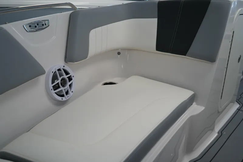 Slide: The Image of 2024 Chaparral 23 SSi OB boat interior with cushioned seating and speaker. - 32