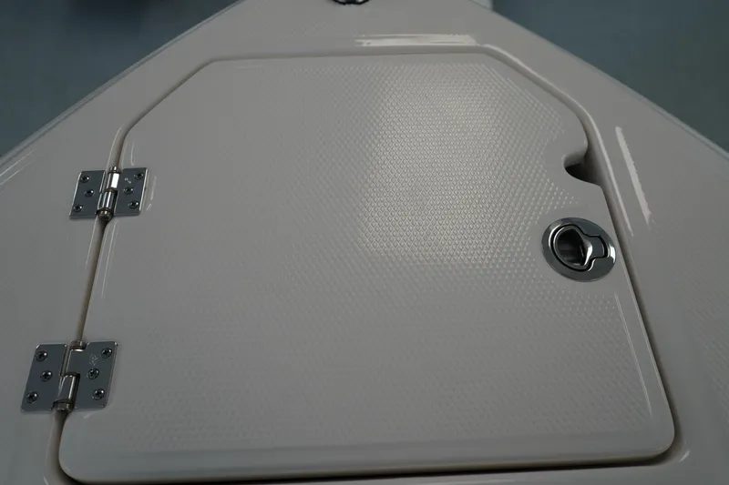 Slide: The Image of 2024 Chaparral 23 SSi OB boat hatch with textured surface and metal latch. - 38