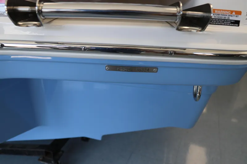 Slide: The Image of 2024 Chaparral 23 SSi OB boat, blue hull detail with chrome accents. - 42