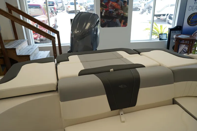 Slide: The Image of 2024 Chaparral 23 SSi OB boat interior with cushioned seating and outboard motor. - 5