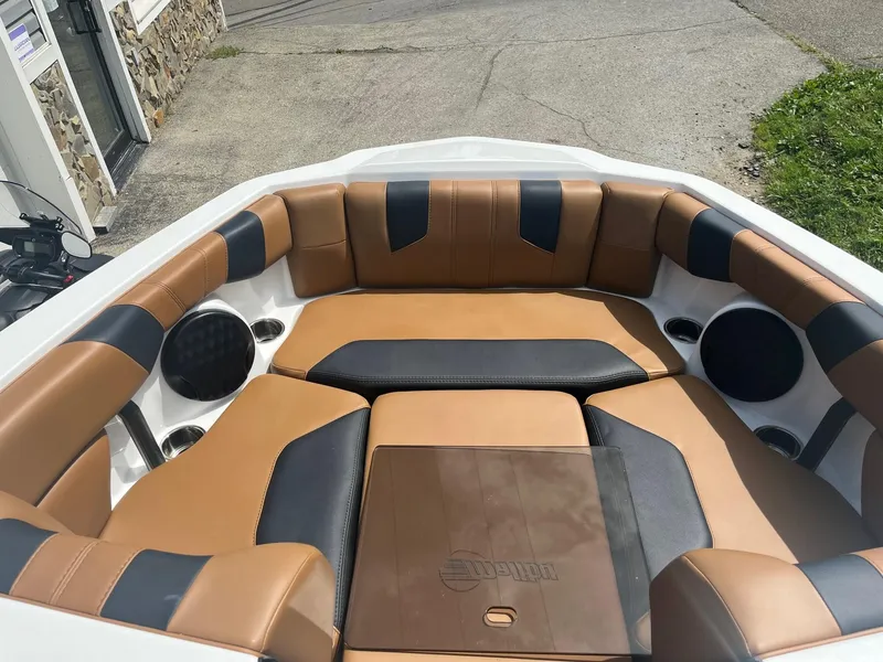 Slide: The Image of 2024 Malibu 21 LX boat interior with tan and black seating. - 7