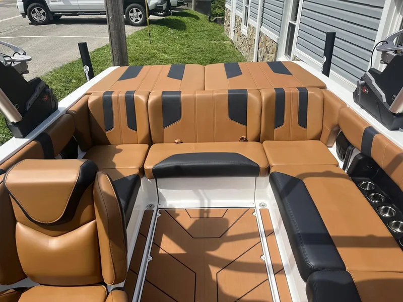 Slide: The Image of 2024 Malibu 21 LX boat interior with tan and black seating. - 9