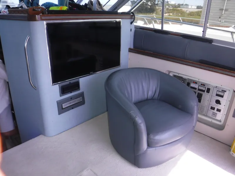 Slide: The Image of Luxurious interior of 1988 Trojan 12 Meter yacht with leather chair and entertainment system. - 11