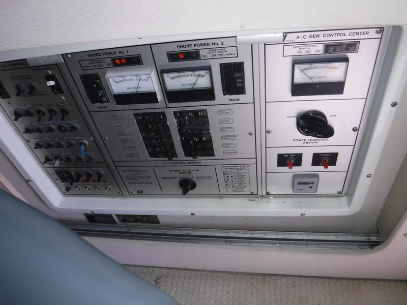 Slide: The Image of Control panel of a 1988 Trojan 12 Meter boat with various switches and gauges. - 12