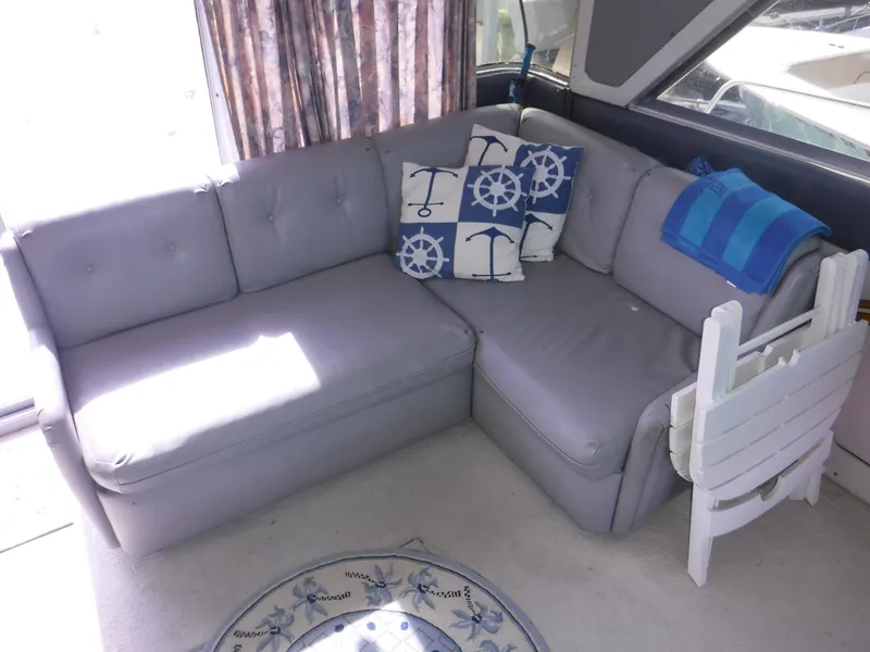 Slide: The Image of Gray sectional sofa with nautical-themed pillows on a 1988 Trojan 12 Meter boat. - 13