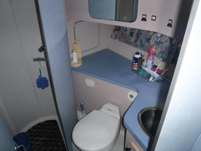 Slide: The Image of 1988 Trojan 12 Meter yacht bathroom with toilet, sink, and toiletries. - 16