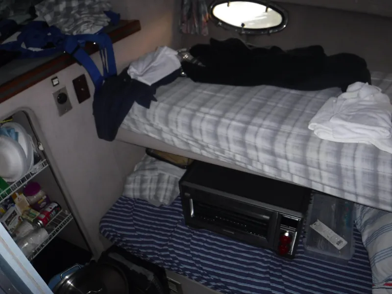 Slide: The Image of Interior of 1988 Trojan 12 Meter boat with bunk beds and storage shelves. - 21