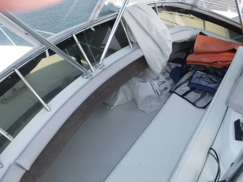 Slide: The Image of 1988 Trojan 12 Meter boat interior with seating and storage, featuring nautical equipment. - 28