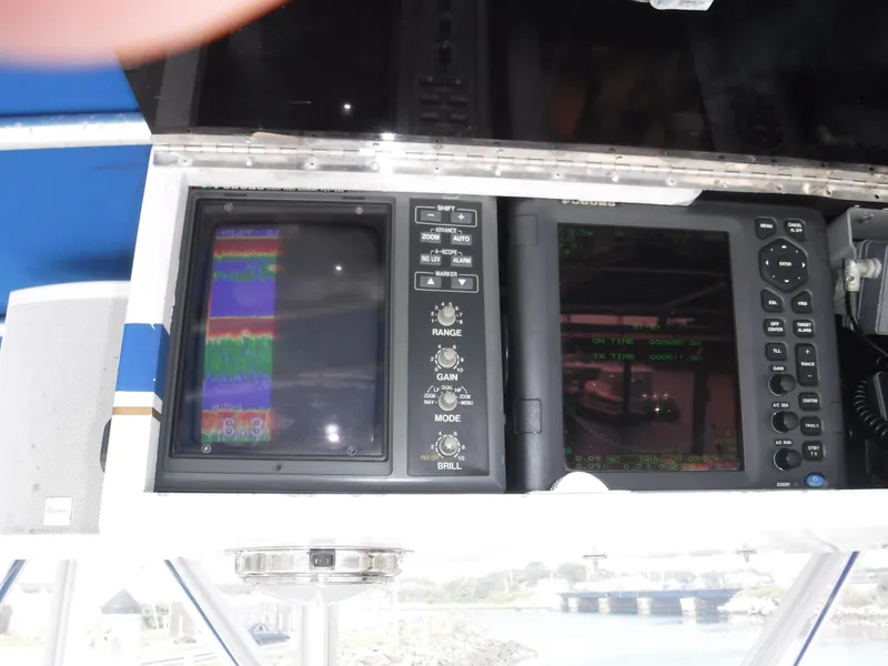 Slide: The Image of Control panel of a 1988 Trojan 12 Meter boat with navigation screens. - 30