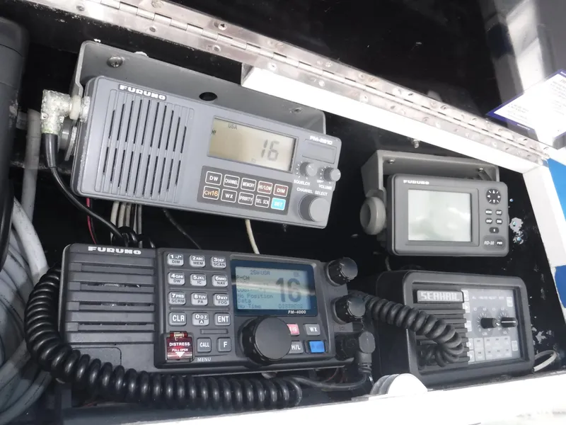 Slide: The Image of 1988 Trojan 12 Meter boat electronics, featuring Furuno communication and navigation equipment. - 31