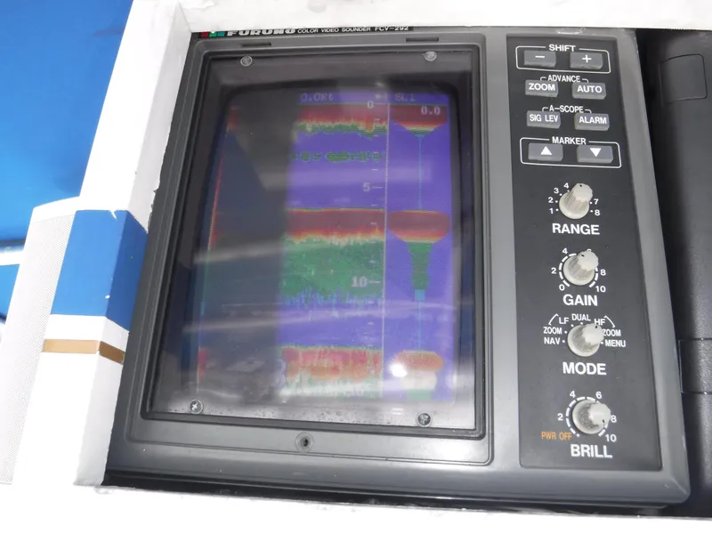 Slide: The Image of 1988 Trojan 12 Meter boat sonar display with range, gain, and mode controls. - 33