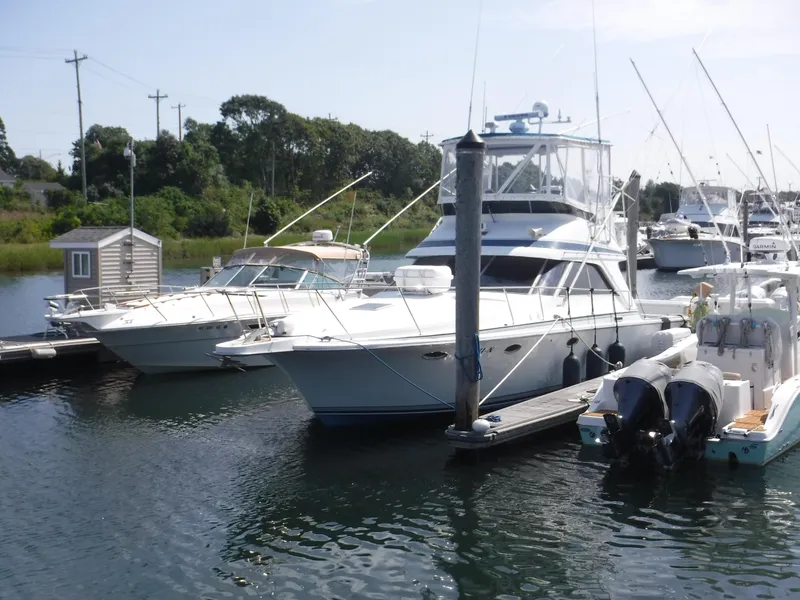 Slide: The Image of 1988 Trojan 12 Meter yacht docked in a marina with other boats. - 45