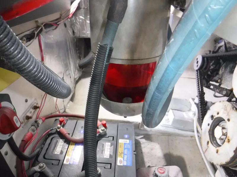 Slide: The Image of Engine room of a 1988 Trojan 12 Meter boat, featuring battery and wiring components. - 8