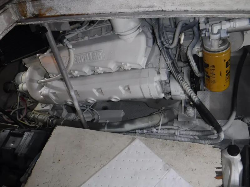 Slide: The Image of Engine compartment of a 1988 Trojan 12 Meter boat, featuring a Caterpillar engine. - 9