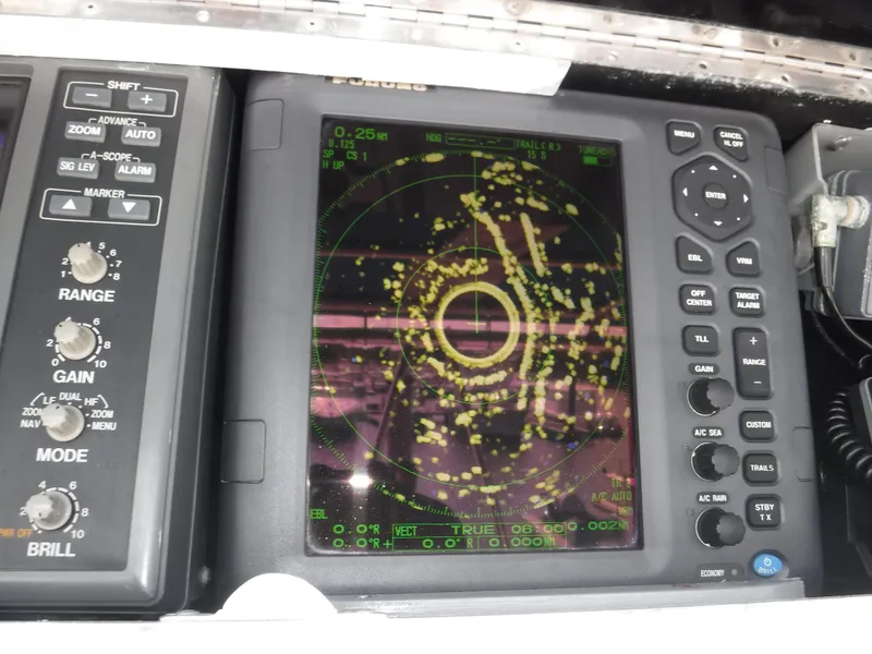 Slide: The Image of Radar display on a 1988 Trojan 12 Meter boat, showing navigation data. - 32