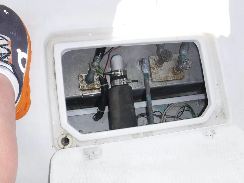 Slide: The Image of 1988 Trojan 12 Meter boat compartment with visible wiring and components. - 44