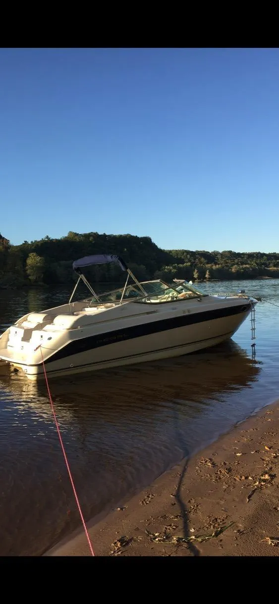 The Image of 1997 Regal Ventura 8.3 SC boat docked on a serene lake shore. - 0