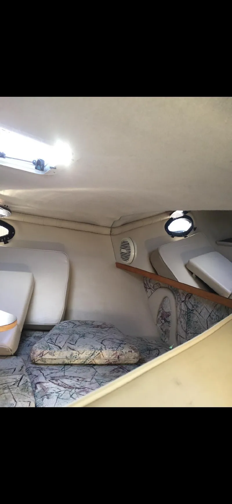 Slide: The Image of Interior cabin of 1997 Regal Ventura 8.3 SC boat with seating and cushions. - 12