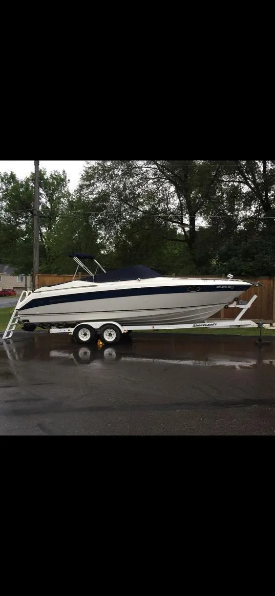 Slide: The Image of 1997 Regal Ventura 8.3 SC boat on trailer, parked on wet pavement. - 5