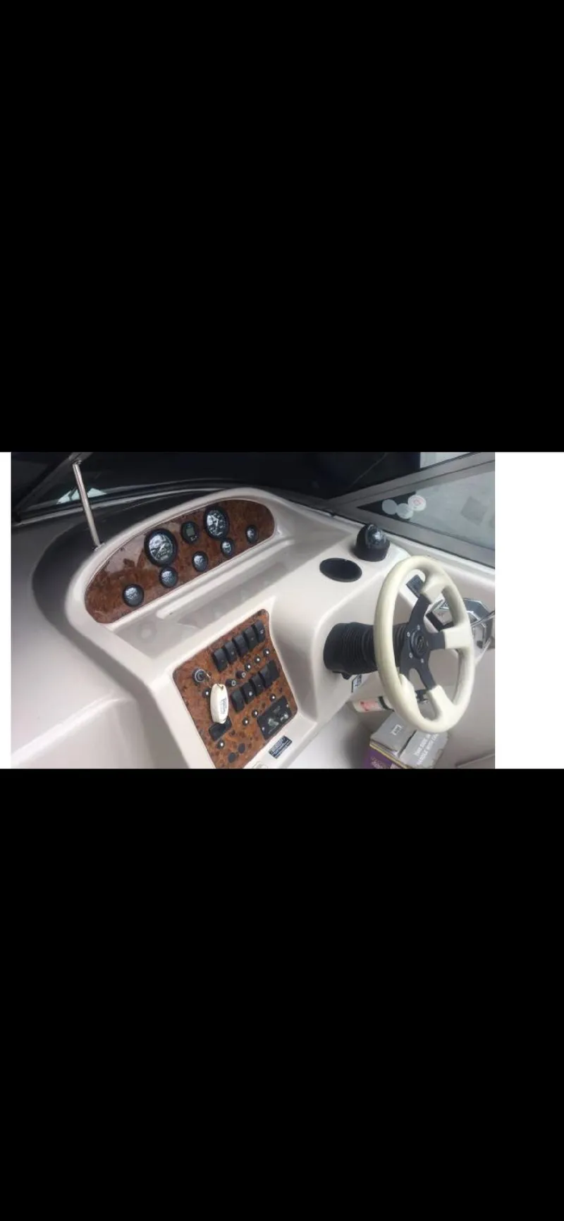 Slide: The Image of 1997 Regal Ventura 8.3 SC boat dashboard with steering wheel and control panel. - 6