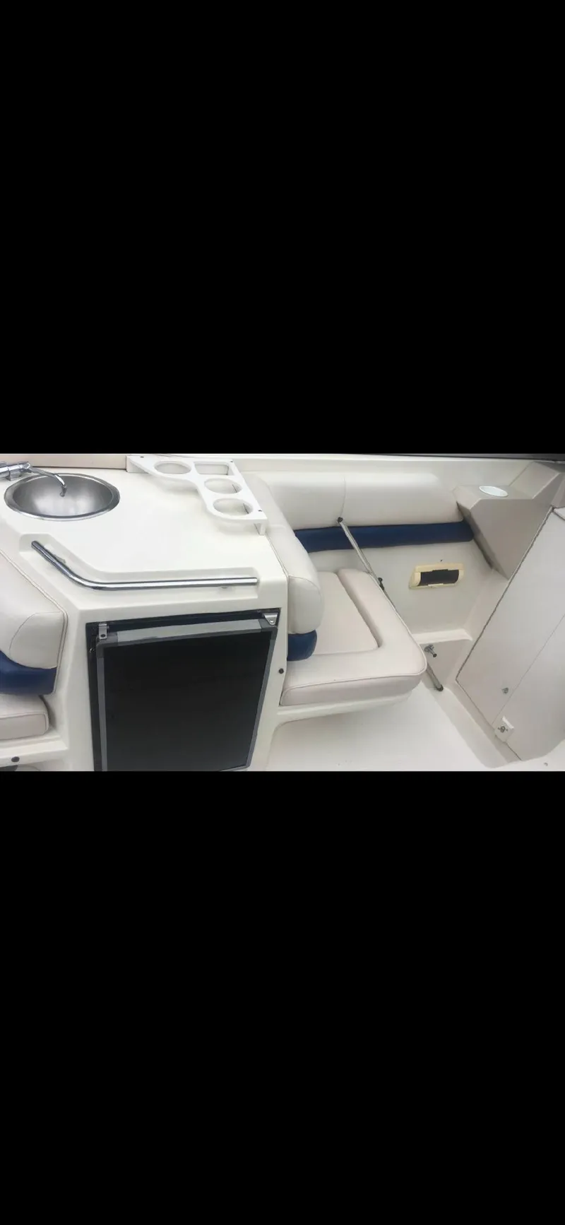 Slide: The Image of 1997 Regal Ventura 8.3 SC boat interior with seating and sink area. - 7