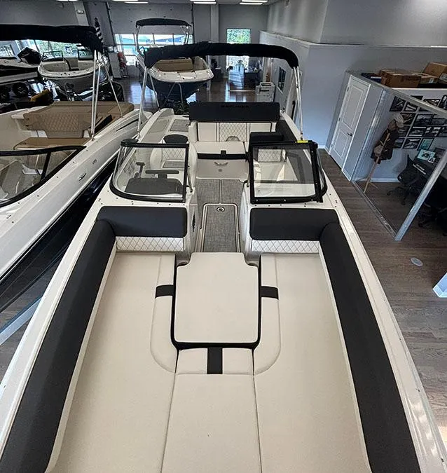 Slide: The Image of 2024 Bayliner DX 2050 boat interior, spacious seating, modern design, showroom display. - 6