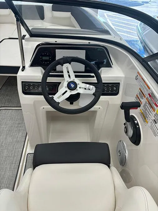 Slide: The Image of 2024 Bayliner DX 2050 boat cockpit with steering wheel and control panel. - 7