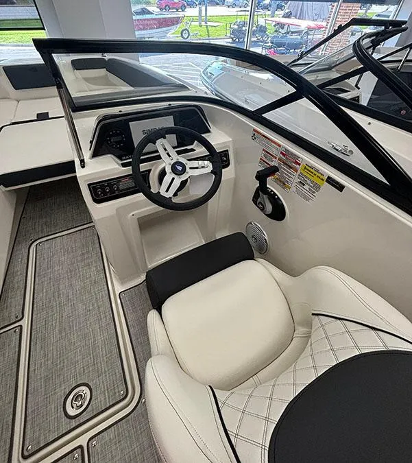 Slide: The Image of 2024 Bayliner DX 2050 boat interior with steering wheel and seating. - 8