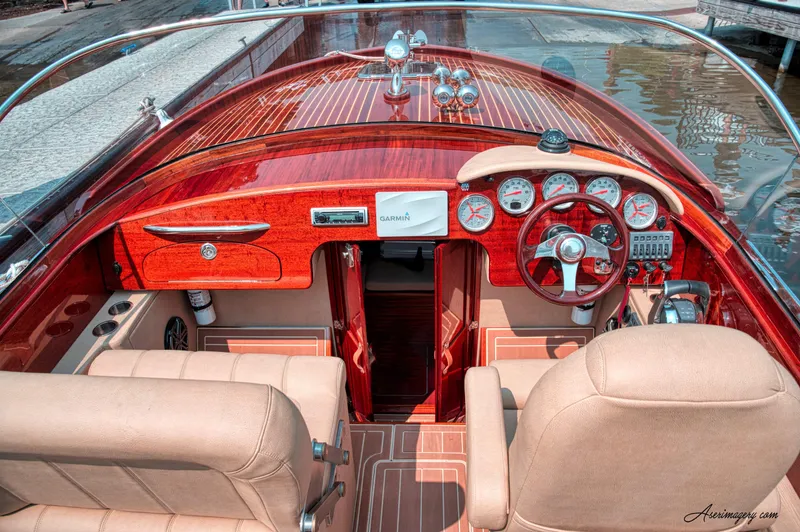 Slide: The Image of Luxurious 2020 Custom Windlea Runabout boat interior with polished wood and beige seating. - 16