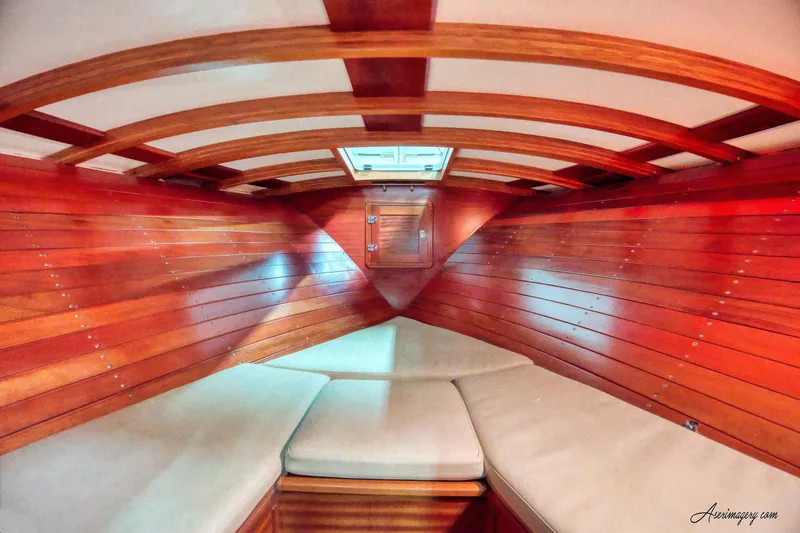 Slide: The Image of Interior of 2020 Custom Windlea Runabout boat with wooden finish and cushioned seating. - 17