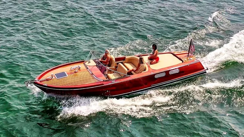 Slide: The Image of Custom 2020 Windlea Runabout boat cruising on open water with passengers. - 2
