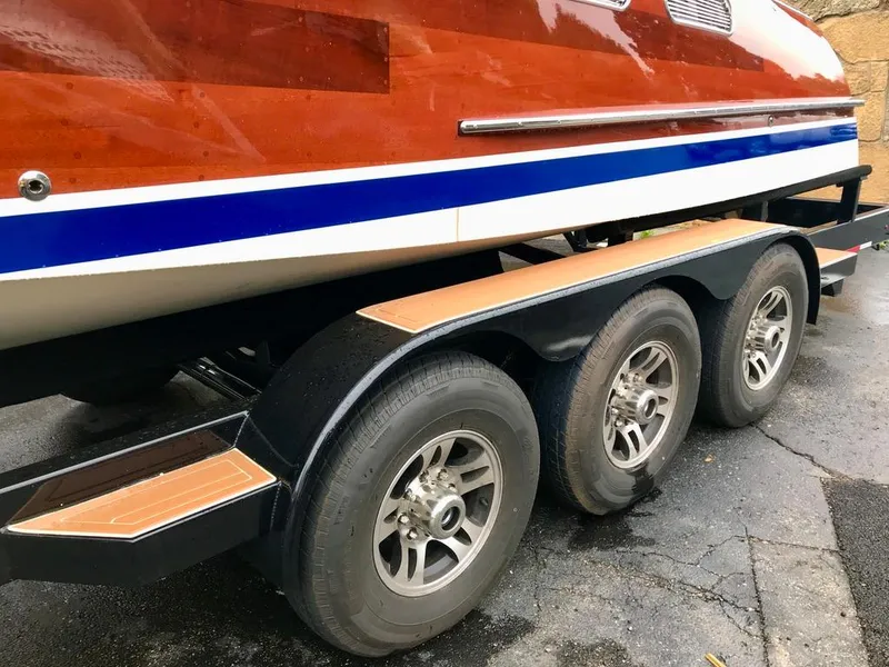 Slide: The Image of Custom 2020 Windlea Runabout boat on a triple-axle trailer, showcasing sleek design. - 35