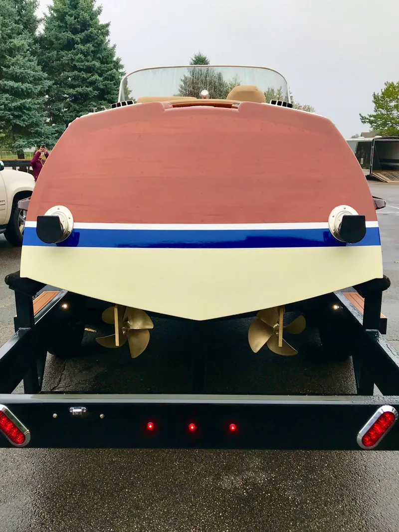 Slide: The Image of 2020 Custom Windlea Runabout boat on trailer, showcasing dual propellers and sleek wooden design. - 37