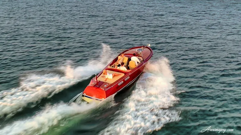 Slide: The Image of A 2020 Custom Windlea Runabout boat cruising swiftly on open water. - 4