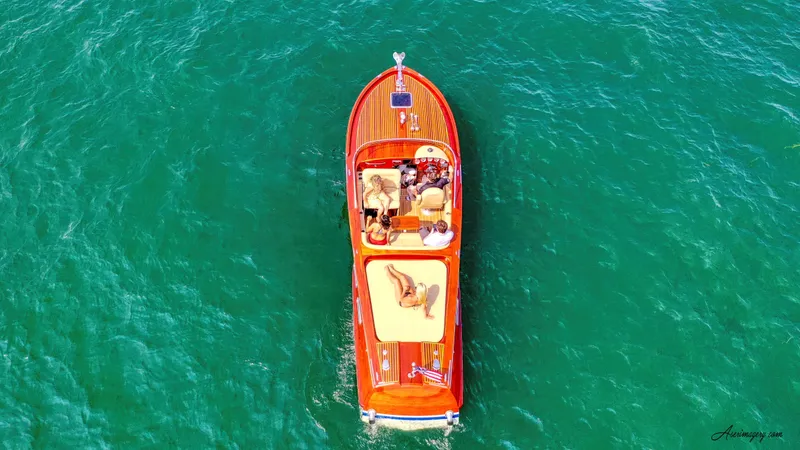 Slide: The Image of Aerial view of 2020 Custom Windlea Runabout boat on clear turquoise water. - 8