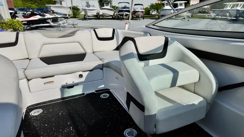 Slide: The Image of 2015 Yamaha Boats SX190 interior with white and black seating, showcasing modern design. - 11