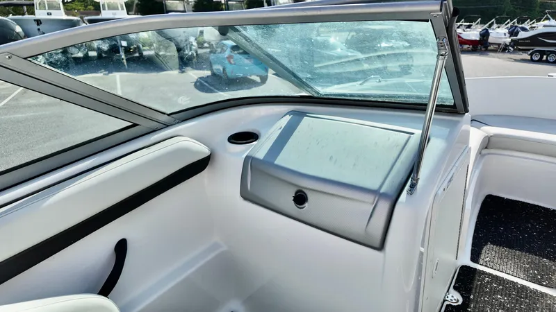 Slide: The Image of 2015 Yamaha Boats SX190 interior with windshield and storage compartment. - 12