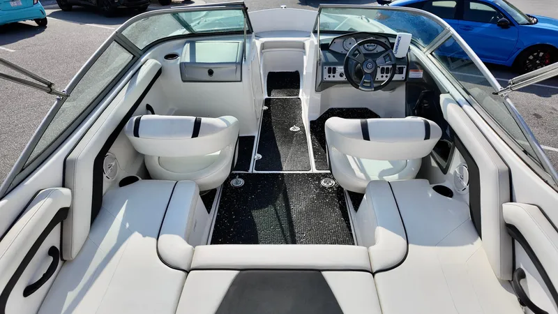 Slide: The Image of 2015 Yamaha Boats SX190 interior with white seating and modern dashboard. - 7