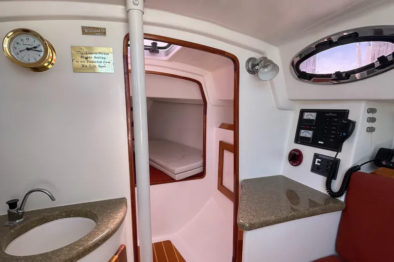 Slide: The Image of Interior cabin of a 2008 Schock Harbor 25 sailboat with sink, bed, and control panel. - 15